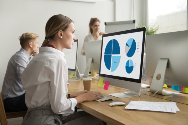 woman looking at graphs on a computer