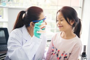 dentist demonstrates for young patient