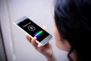 woman uses voice search functionality on her mobile device